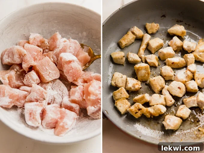 Cubed chicken breast is searing in a hot pan, developing a golden, crispy exterior.