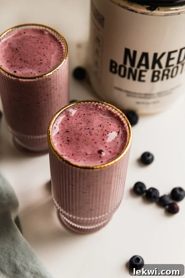 Two tall glasses of power berry smoothie, ready to be enjoyed.