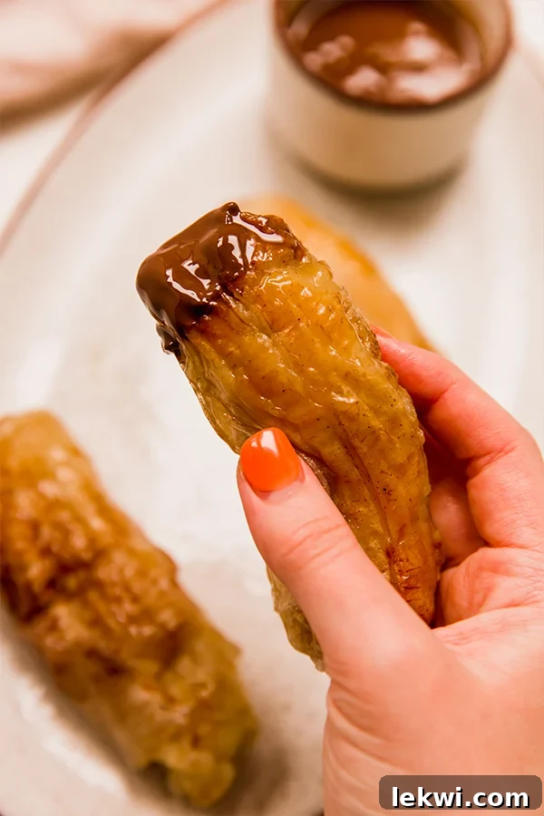 Filipino Banana Lumpia being held in a hand.