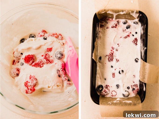 Ice cream and berry mixture being added to a lined loaf pan.