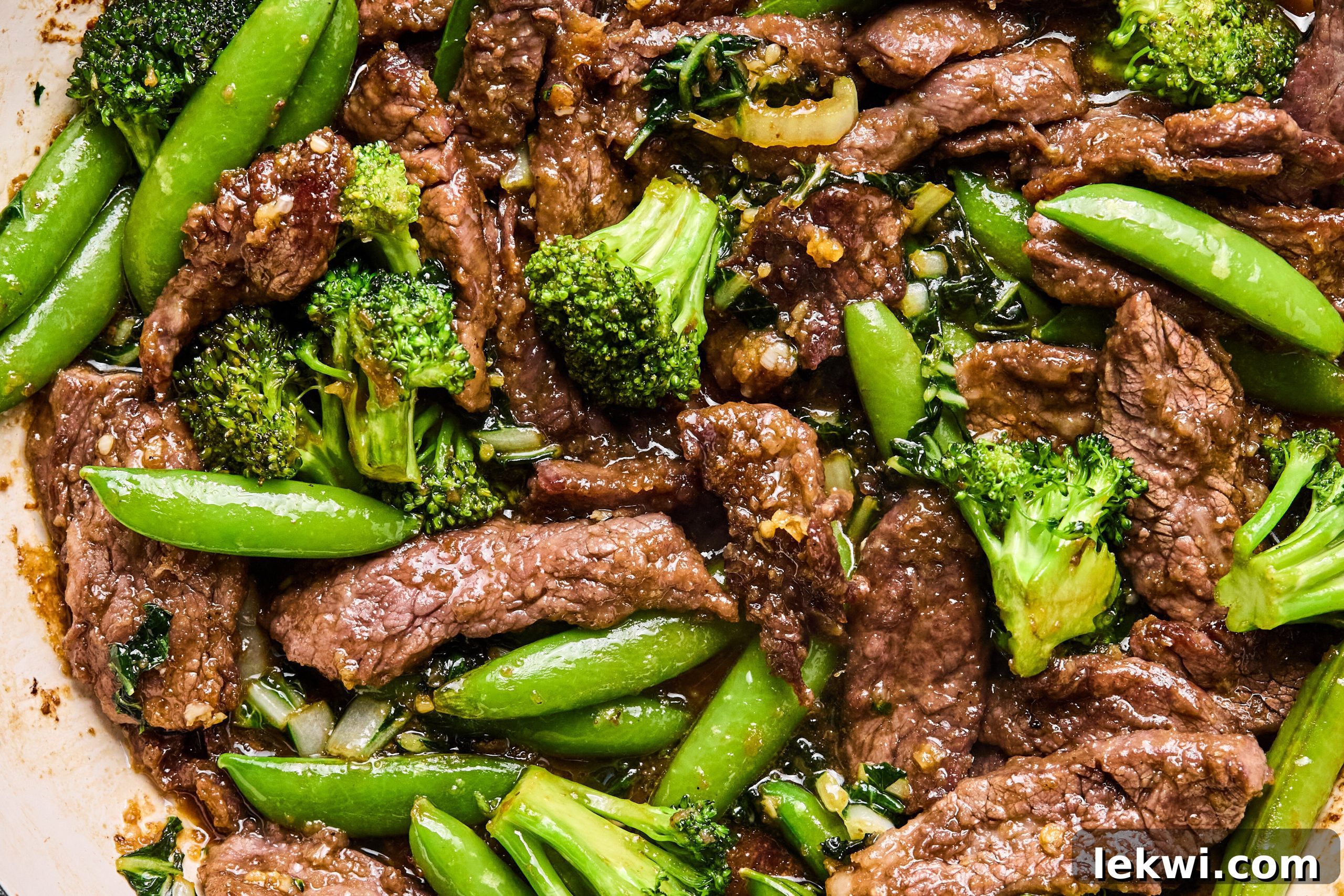 The final stir fry with the flank steak and vegetables and sauce in the pan before serving. 