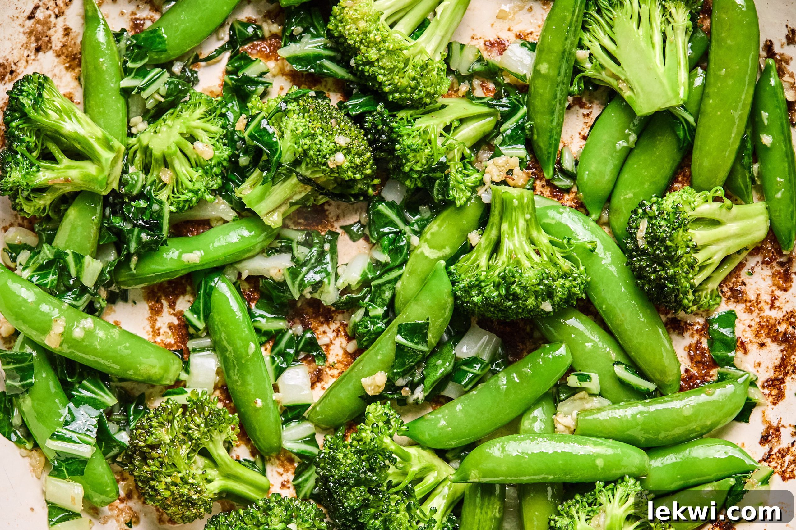 The vegetables sauting in a pan.