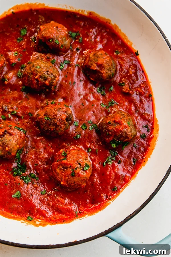 Italian lamb meatballs in sauce in a pan.