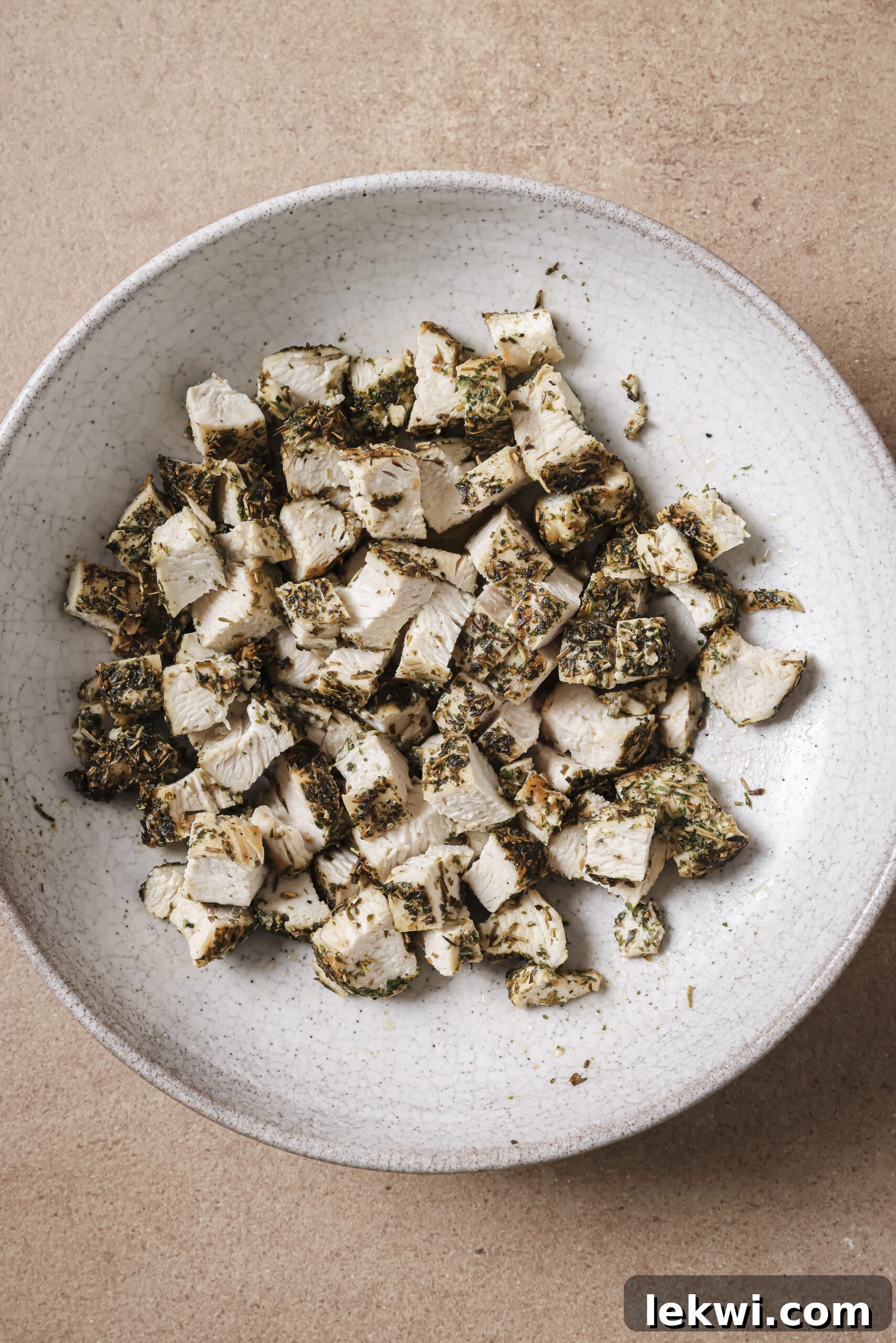 Cooked and seasoned chicken diced in a bowl.