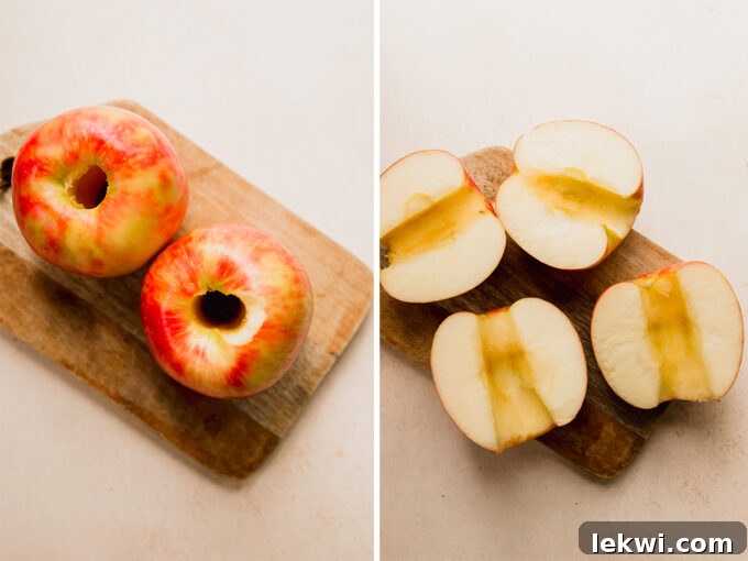 Hands demonstrating the process of coring and slicing apples in half, preparing them for the air fryer.