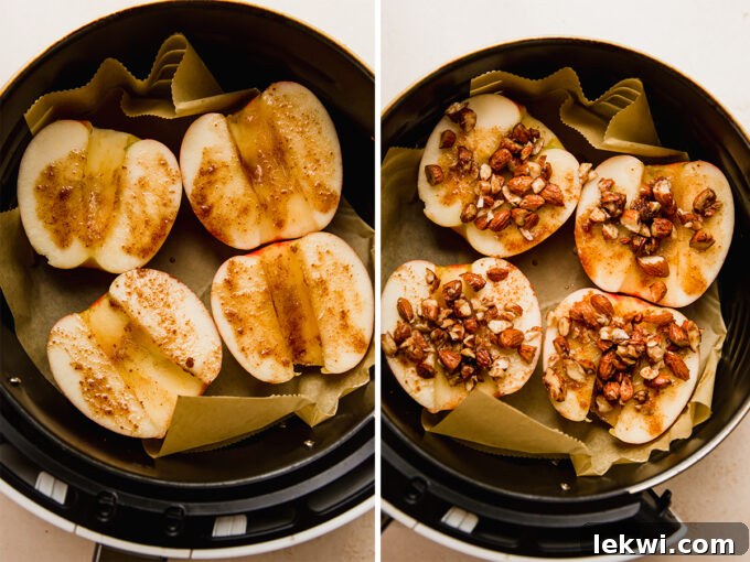 Apple halves, cored and brushed with a spiced mixture, topped with almonds and placed in an air fryer basket lined with parchment paper.