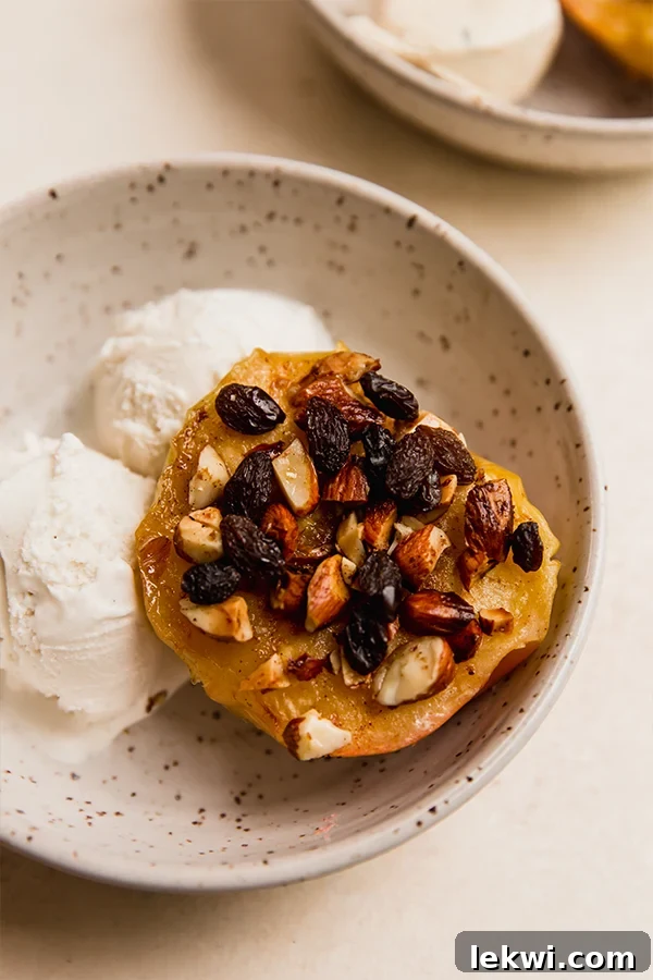 Dairy-free ice cream and a baked apple in a bowl.