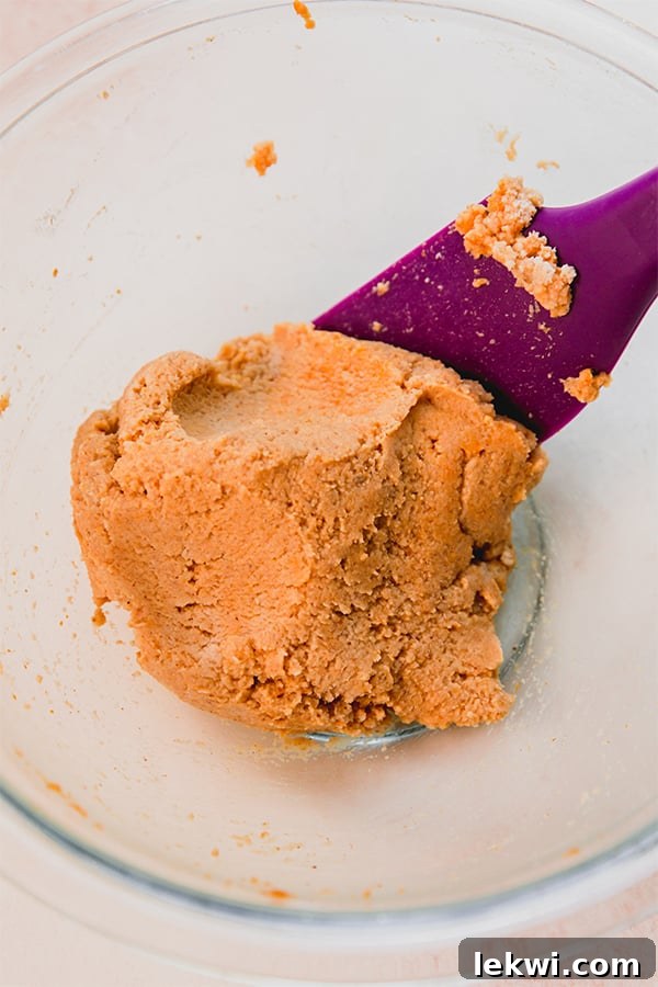 The thick pumpkin waffle batter in a white bowl.