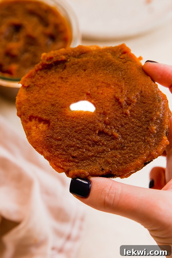 A perfectly toasted bagel generously spread with homemade pumpkin butter, ready for a delicious breakfast or snack.