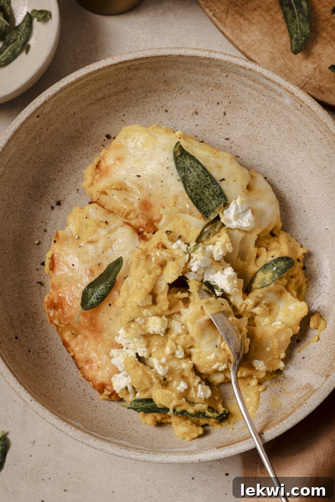 Butternut lasagna roll ups topped with crispy sage in a bowl