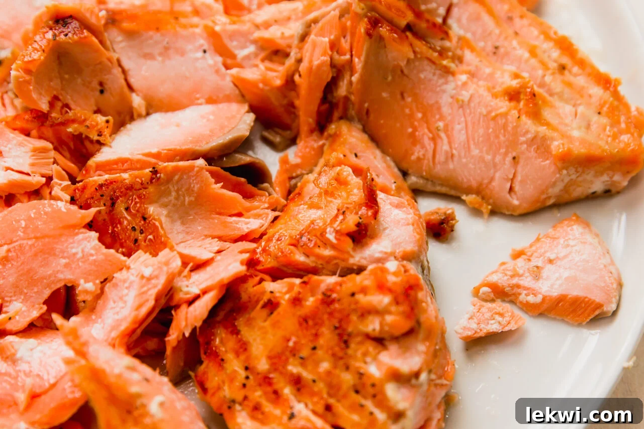 Salmon flaked on a plate.