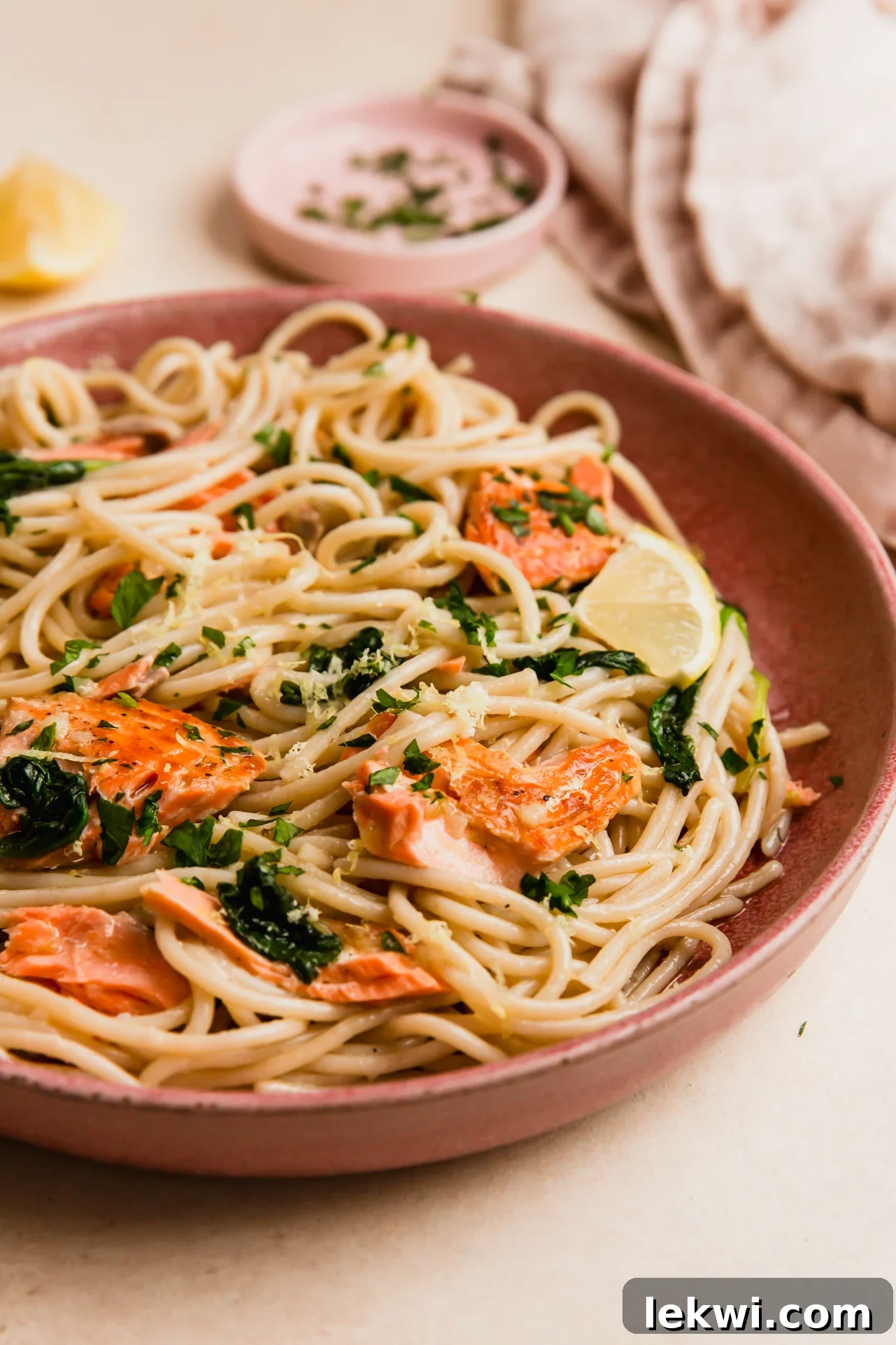 Lemon salmon pasta in a pink bowl.