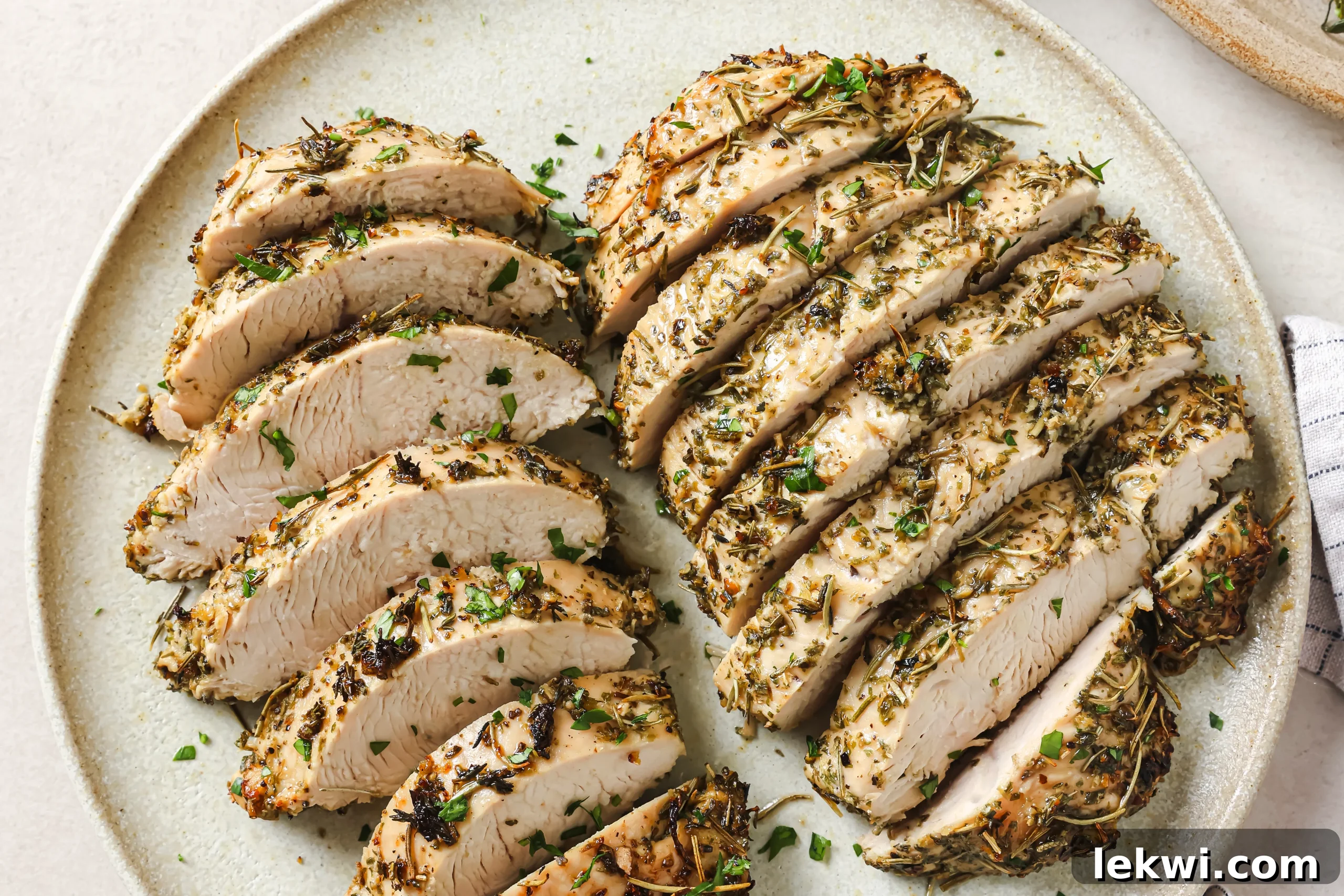Perfectly sliced turkey tenderloins on a plate, revealing a moist, tender interior.