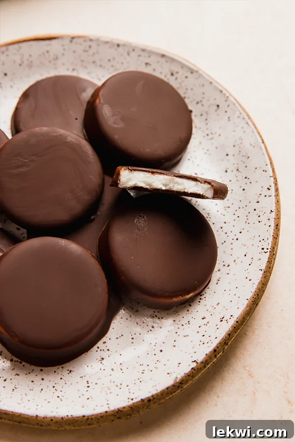 Plate of peppermint patties, one of which is missing a bite.