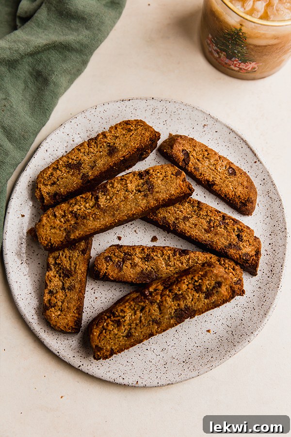 A beautifully arranged plate filled with several gluten-free chocolate chip biscotti, highlighting their inviting appearance.