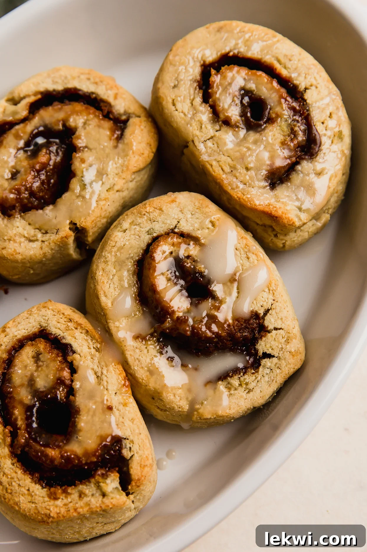 Freshly baked gluten-free gingerbread cinnamon rolls in a baking tray, ready to be served.