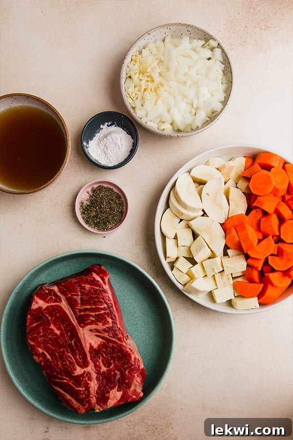 All the fresh and dried ingredients laid out for making oven-baked chuck roast, showcasing a colorful array of vegetables and herbs.