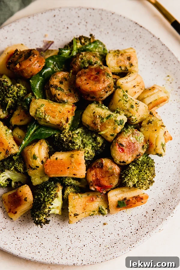 Gnocchi, sausage, and vegetables perfectly arranged on a plate for a hearty meal.