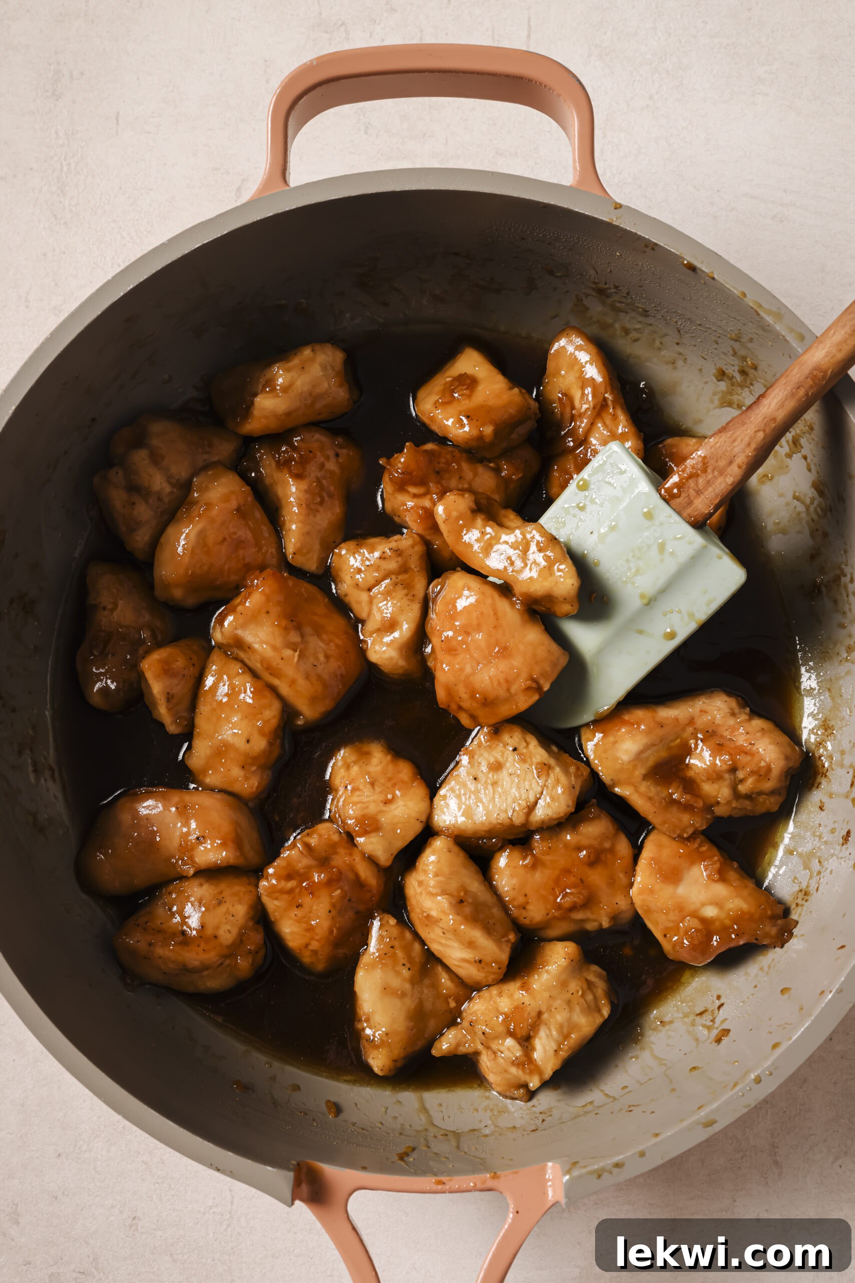 Cooked chicken, cubed in a pan tossed with a honey butter sauce.
