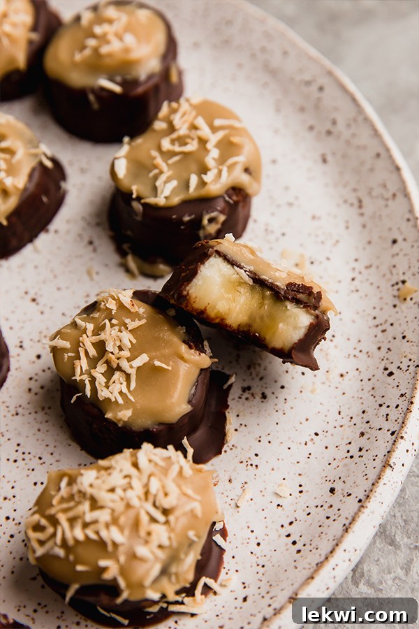 A beautifully presented plate of Samoa Banana Bites, showcasing their rich chocolate, golden caramel, and toasted coconut layers.