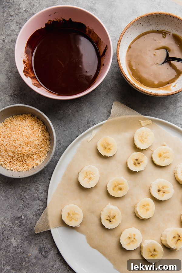 All the fresh ingredients laid out for making Samoa Banana Bites, including ripe bananas, dairy-free chocolate chips, shredded coconut, and components for the caramel sauce.