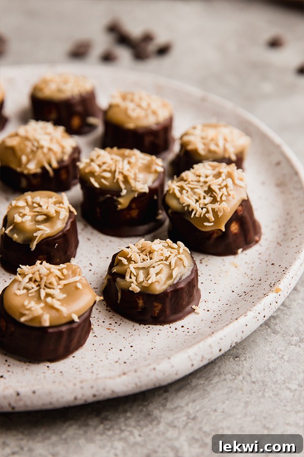 A beautifully presented plate of Samoa Banana Bites, glistening with chocolate, caramel, and toasted coconut, ready to be served.