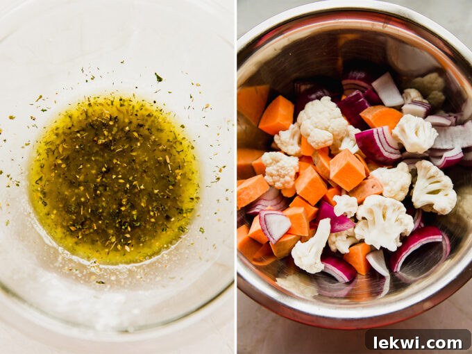 A bowl of olive oil and spices, ready to be mixed, next to a sheet pan with raw vegetables.