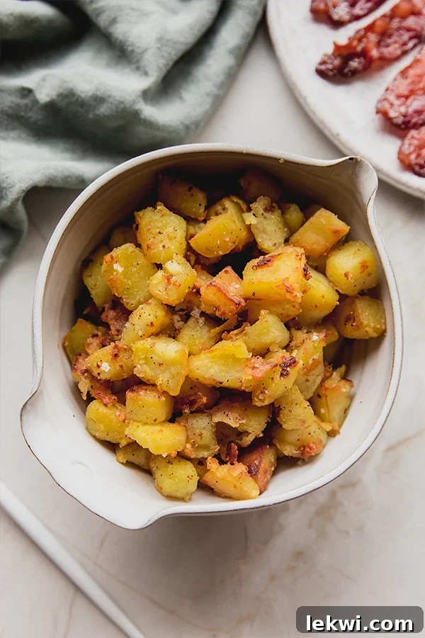 White sweet potatoes in a bowl next to cooked bacon, highlighting a perfect breakfast pairing.