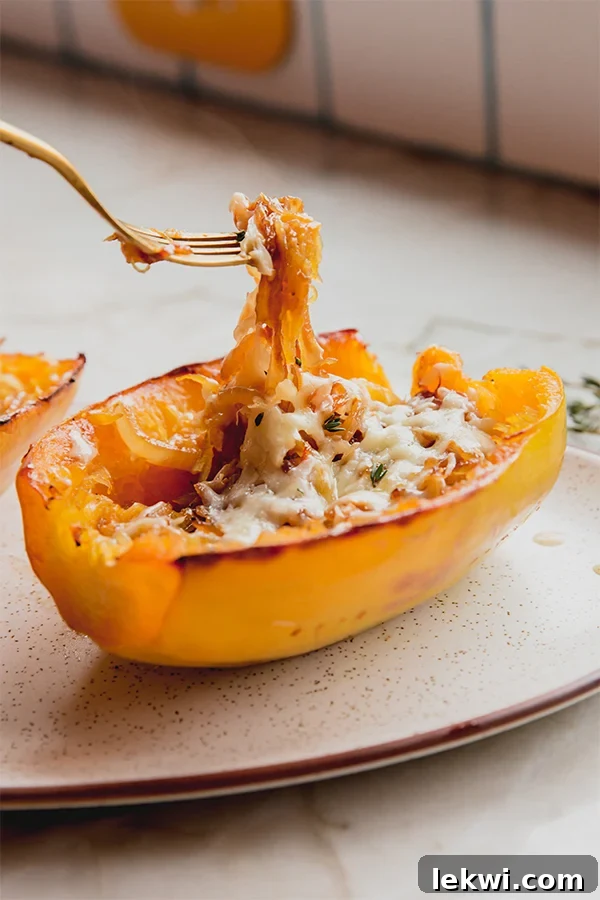 A French onion spaghetti squash boat with a fork inside, ready to be eaten.
