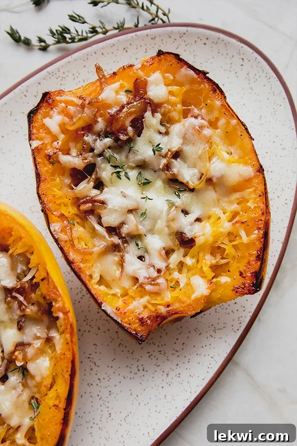 Two French onion spaghetti squash boats on a platter.