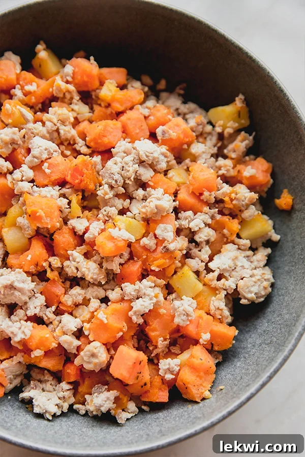 A stovetop skillet filled with colorful, sautéed vegetable hash, lightly browned and steaming.