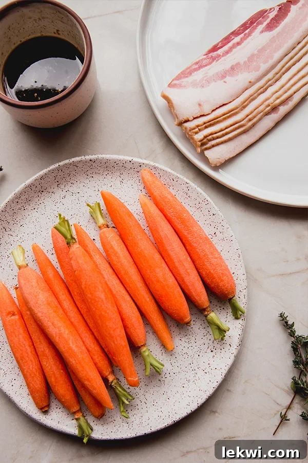 Peeled, slender carrots laid out on a white plate next to raw bacon strips, ready for wrapping.