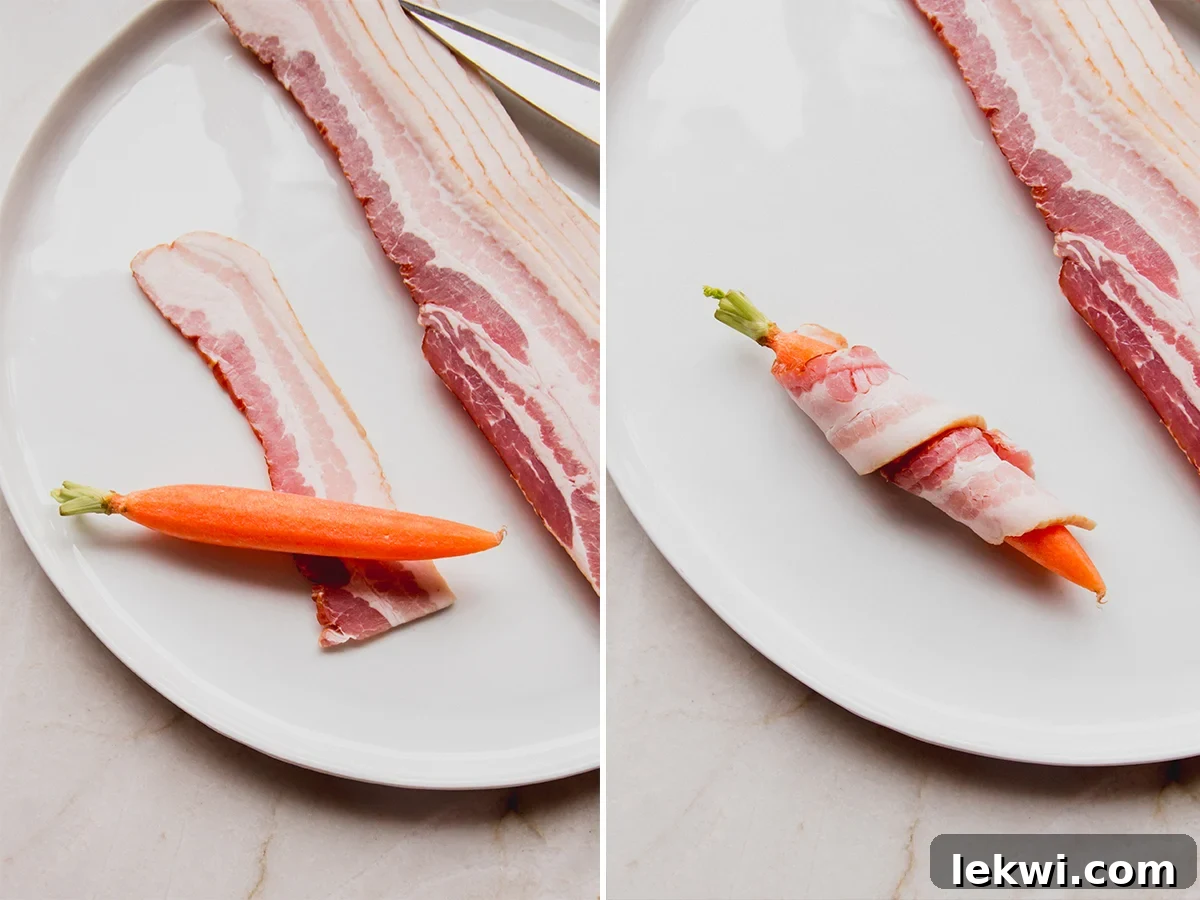 Hands demonstrating how to wrap a strip of raw bacon around a peeled carrot on a wooden surface.