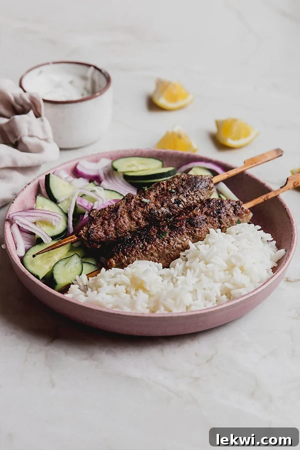 Bowl of vegetables, rice, and beef kofta, ready to be served.