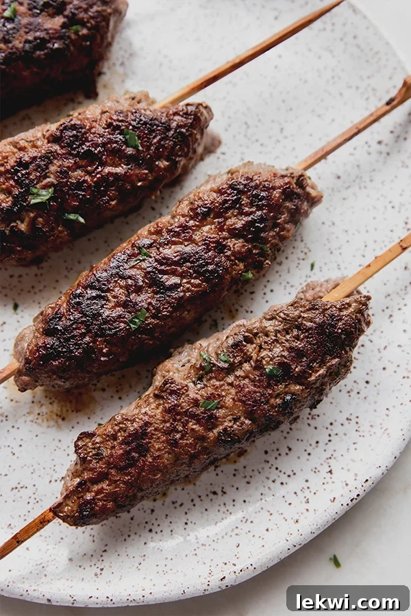 Grilled beef kofta skewers beautifully arranged on a serving plate.