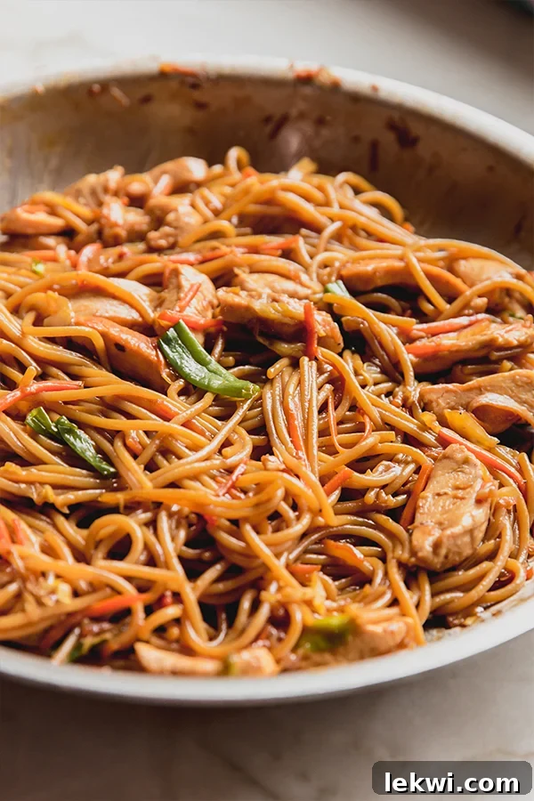 A pan of chicken chow mein after cooking.