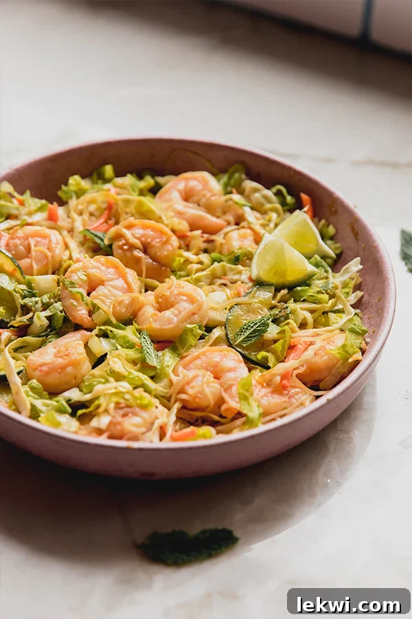 Spring roll in a bowl topped with lime.