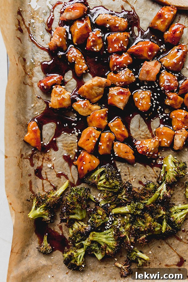 The sheet pan sesame chicken after baking and topped with sauce.
