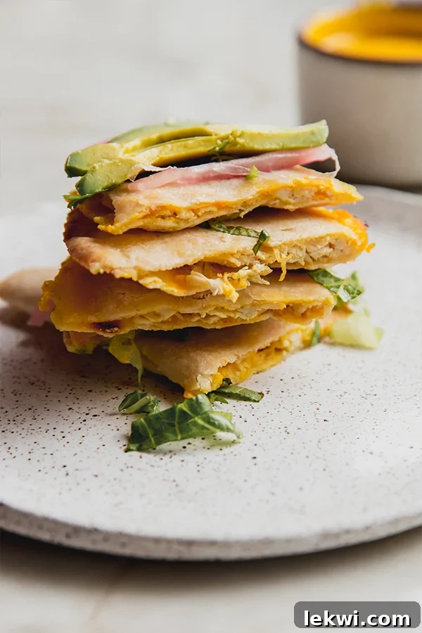 Stack of chicken quesadillas on a plate.
