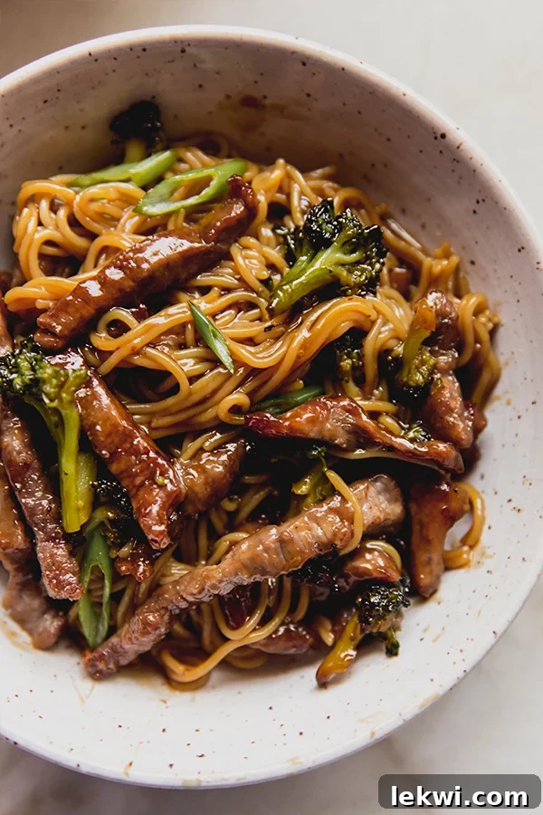 A vibrant bowl of Sheet Pan Beef & Broccoli Ramen, showcasing tender beef, green broccoli, and ramen noodles coated in a rich sauce, ready to be enjoyed.