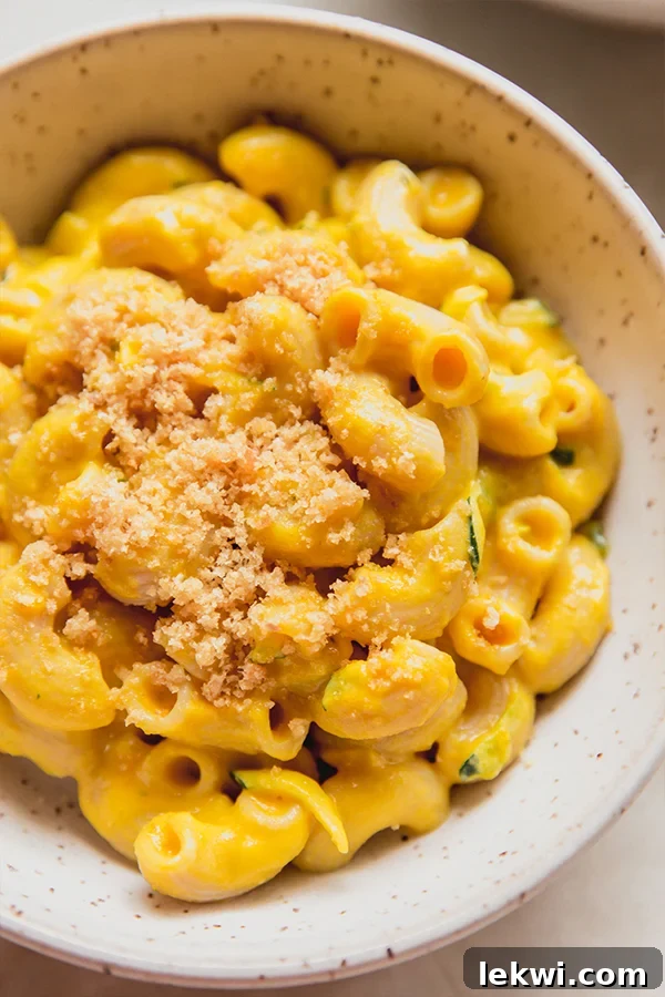 Zucchini mac and cheese topped with crumbs.