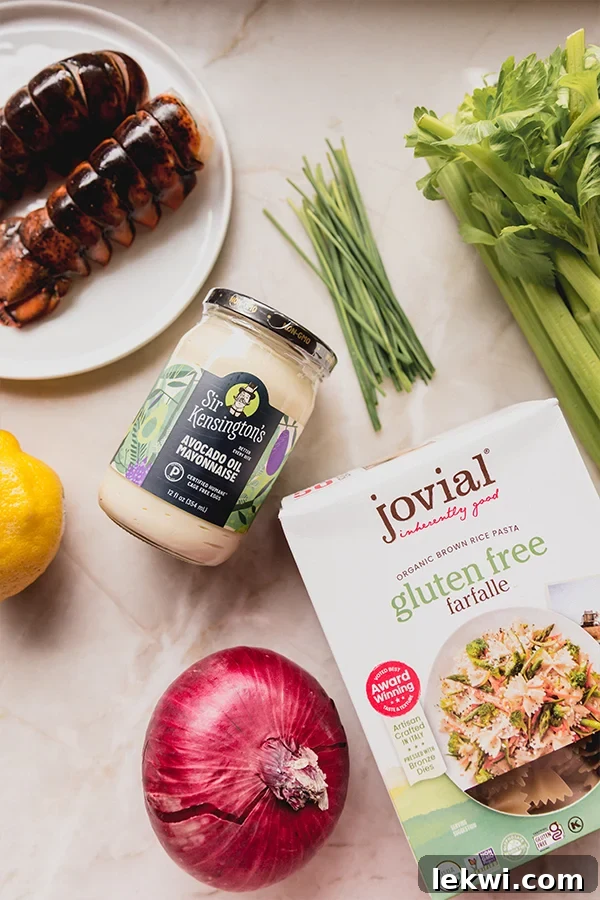 The array of fresh, colorful ingredients for gluten-free lobster roll pasta salad laid out on a kitchen counter, ready for preparation.