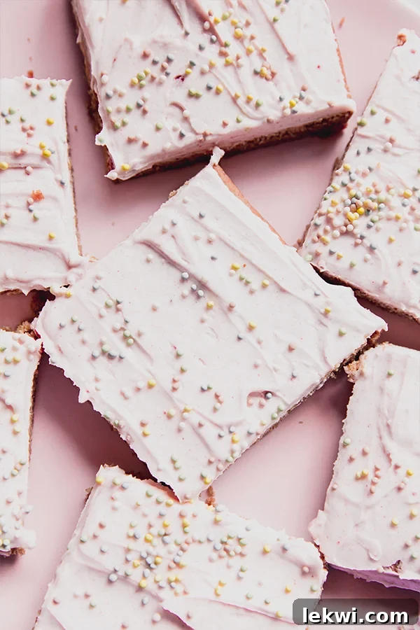 Vibrant funfetti pink sugar cookie bars on a charming pink plate, ready to delight.