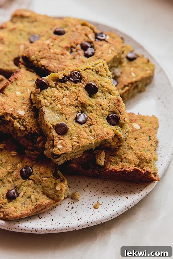 A plate stacked with zucchini breakfast bars stacked on.