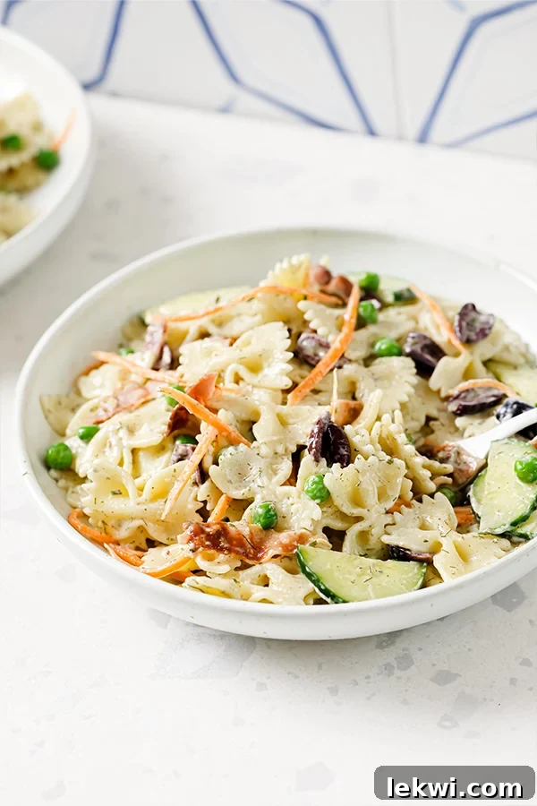 Bowl of bacon ranch bow tie pasta salad, a perfect gluten-free and dairy-free dish for summer.