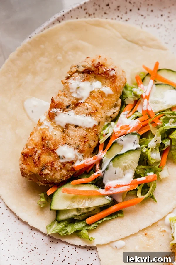 Ranch over chicken and vegetables in a tortilla.