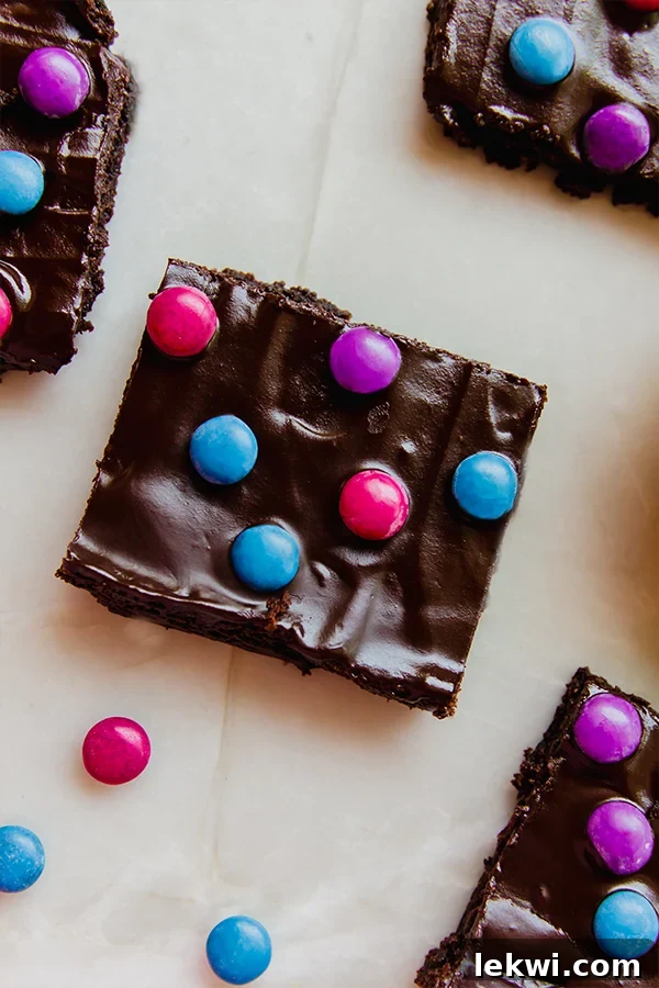 A perfectly portioned piece of fudgy almond flour space brownie, showcasing its rich texture and colorful sprinkles.