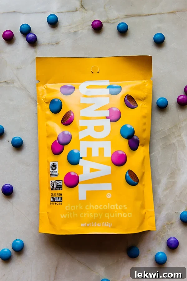 A vibrant bag of Unreal Dark Chocolate with Crispy Quinoa Gems, highlighting their natural colors and wholesome appeal.