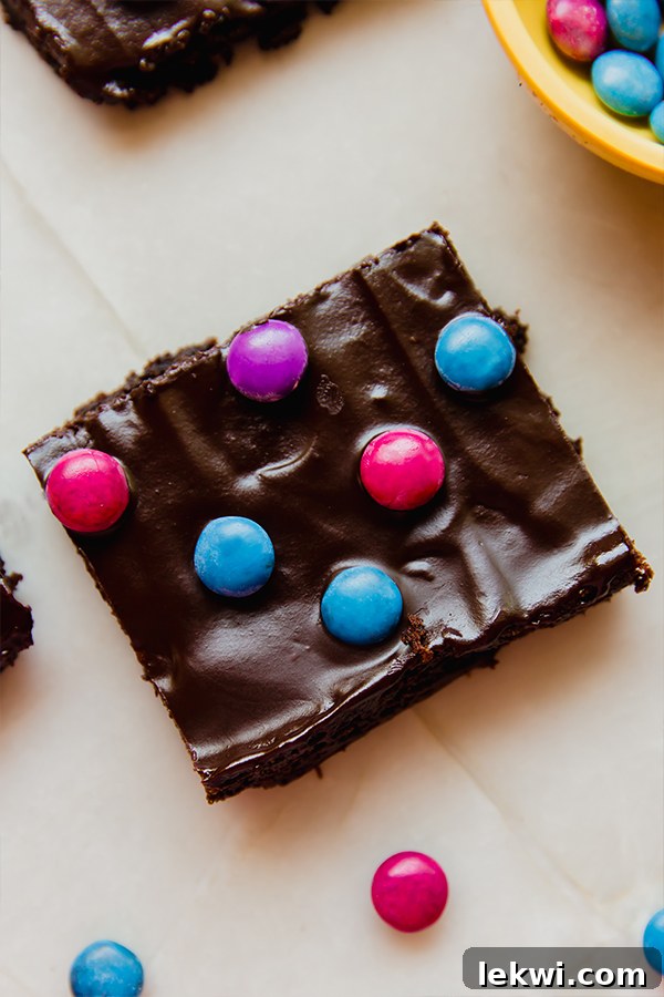 A single, perfectly cut almond flour space brownie resting on parchment paper, ready to be enjoyed.