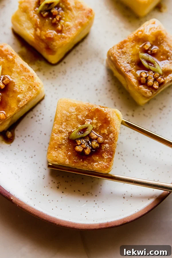 Crispy golden chickpea tofu on a plate, ready to be served as a delicious soy-free alternative.